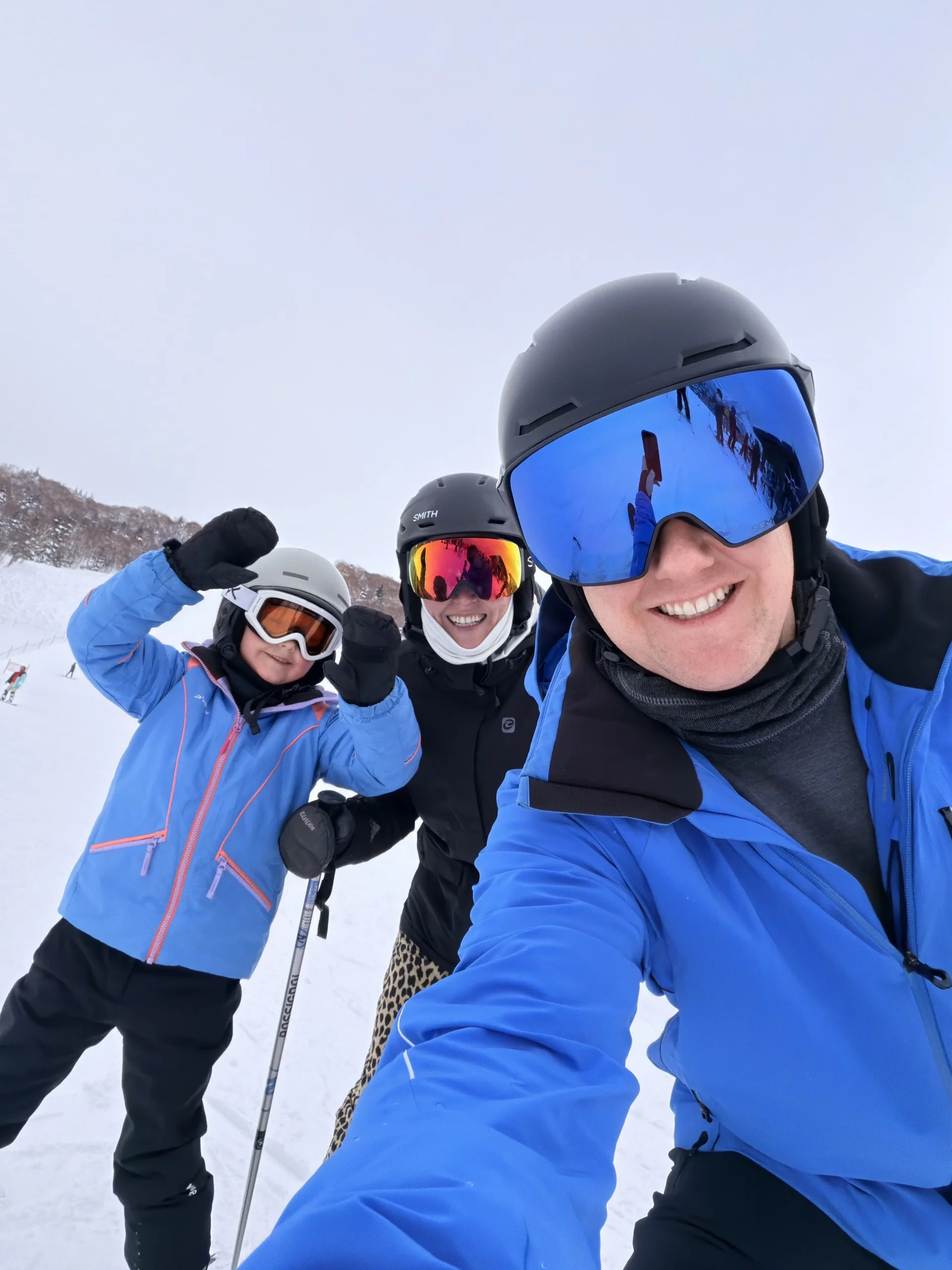 A parent and child in ski gear together on the slopes at a Club Med resort in Hokkaido.