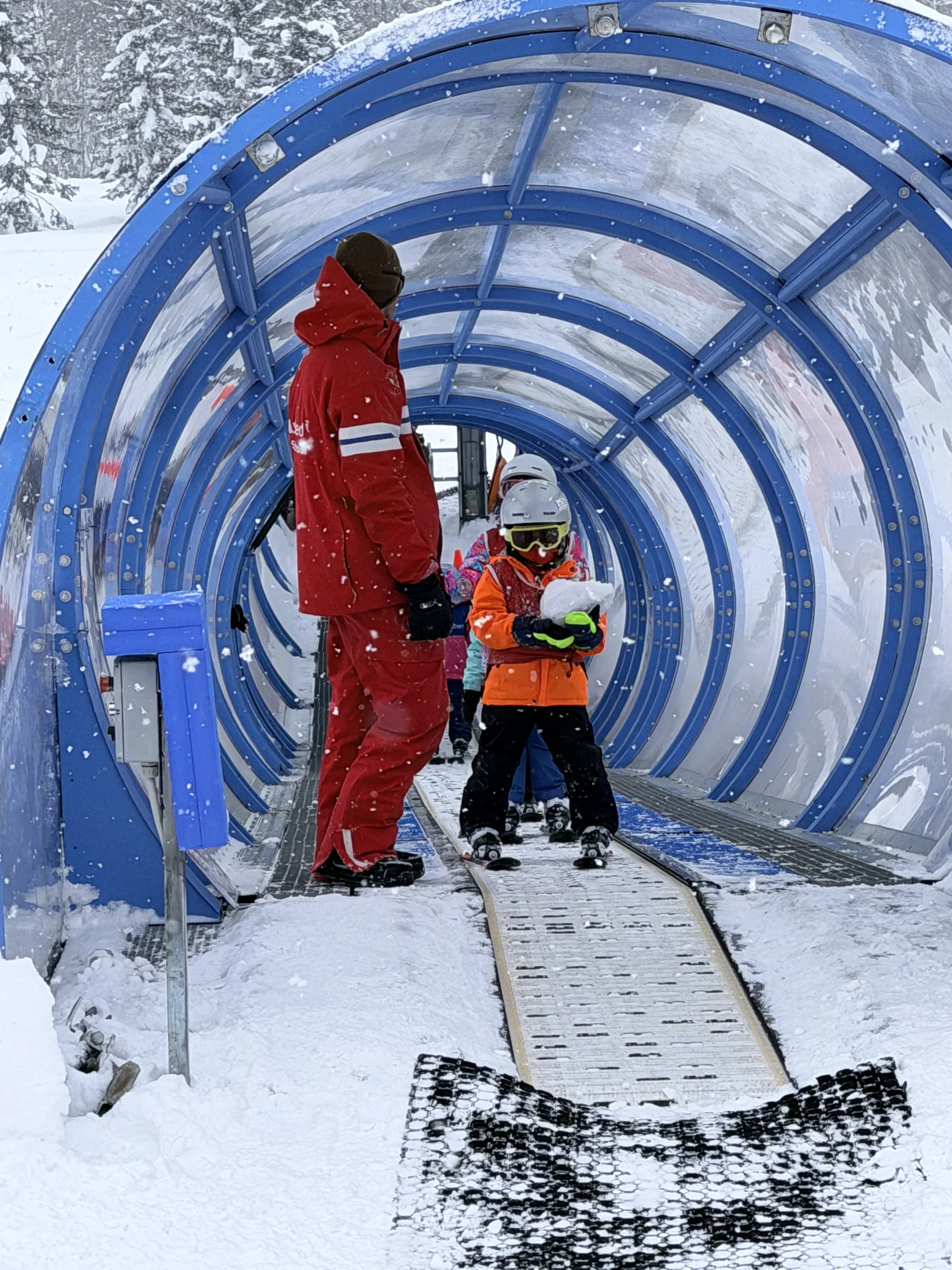 A Club Med ski instructor and young skiers on the covered magic-carpet learners’ lift at a Club Med resort in Hokkaido.